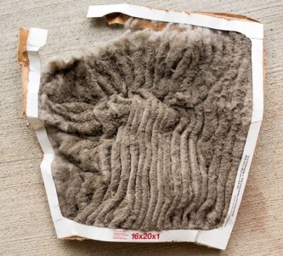 vac air conditioning filter clogged with dust and dirt and falling to pieces after not being changed frequently