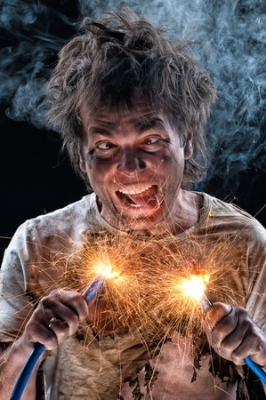 portrait of crazy electrician over black background